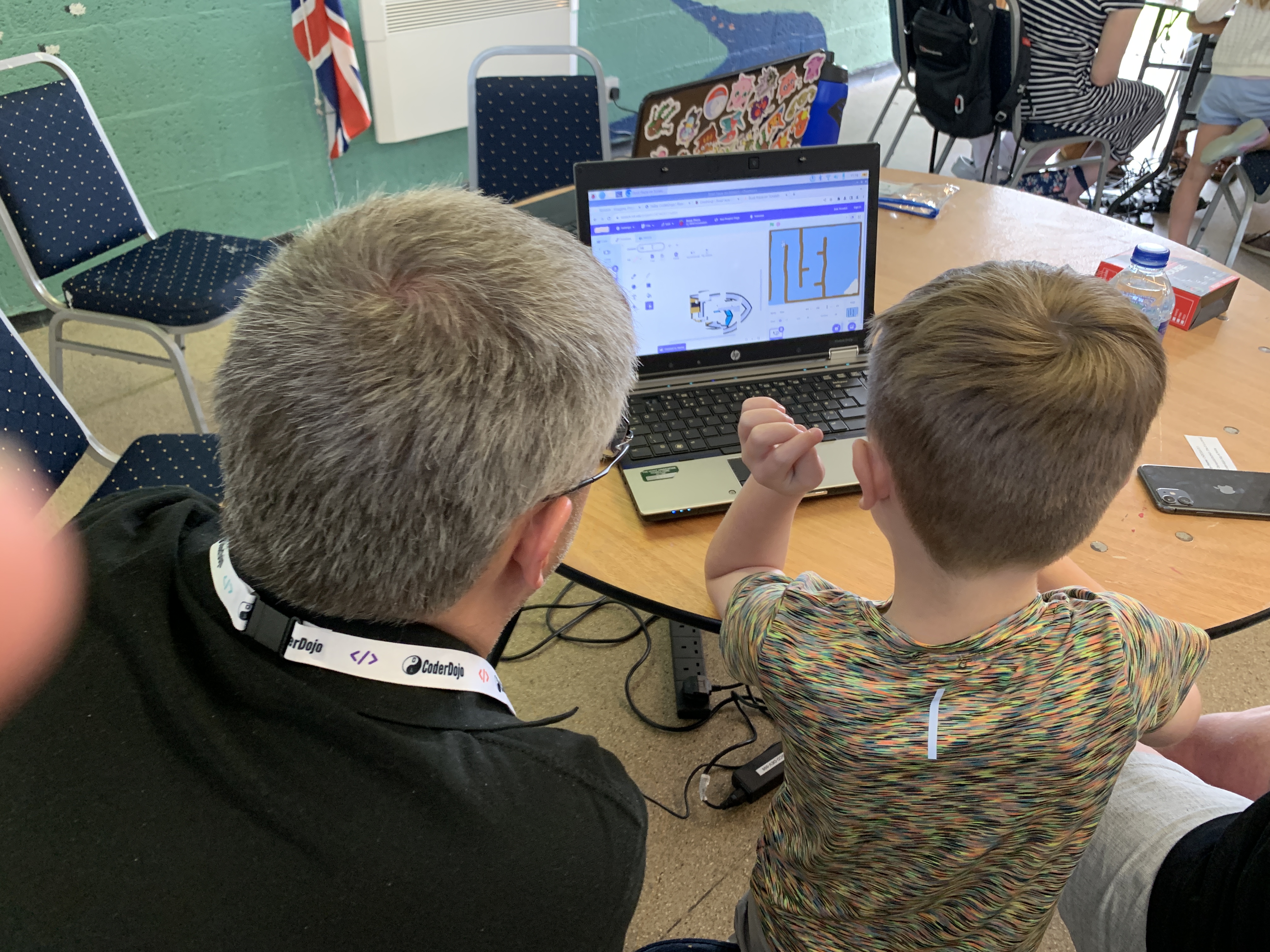 volunteer and young person working on laptop